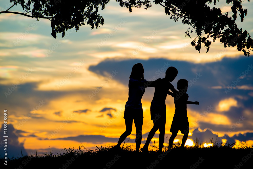 Children playing joyfully In the Sunset.
