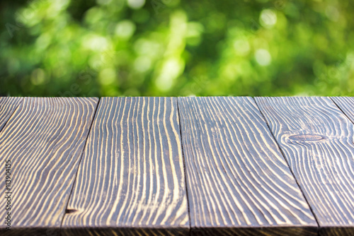 Wooden deck table over beautiful bokeh background