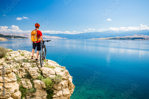 Mountain biker looking at view and riding on bike
