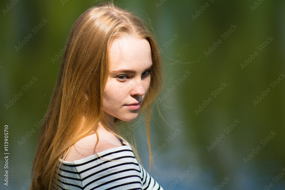 Beautiful young woman in a striped dress
