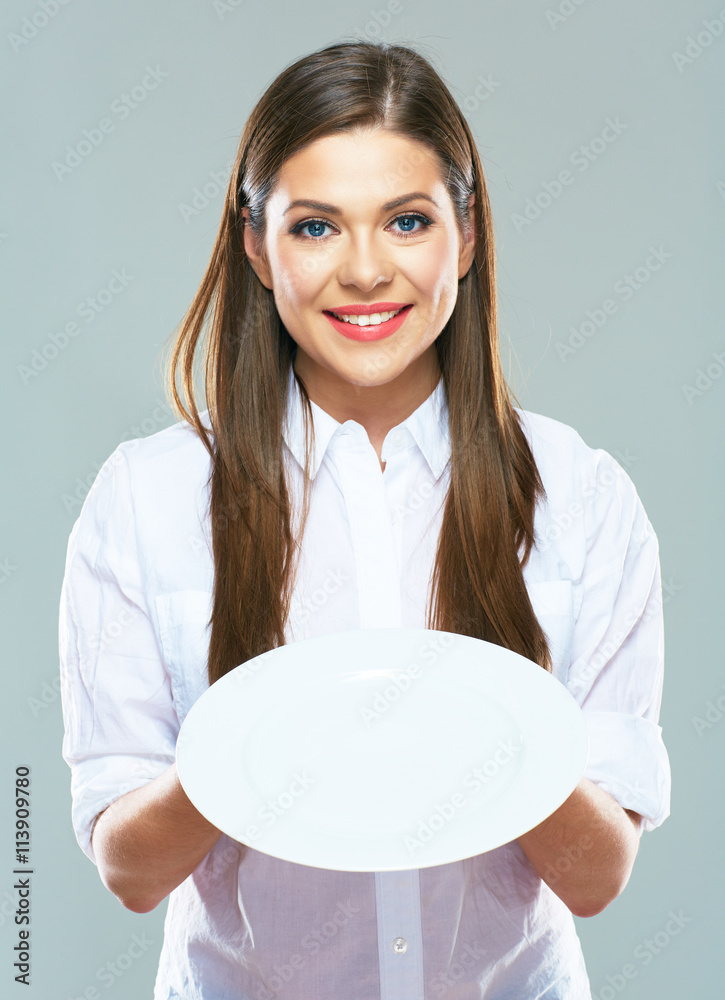 Smiling Business woman holding emty white plate in front. Smiling Business woman holding emty white plate in front.