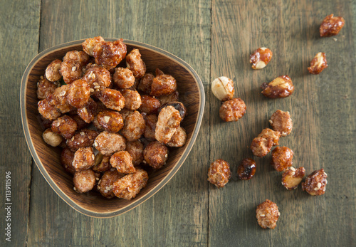 sugared peanuts on the wooden background