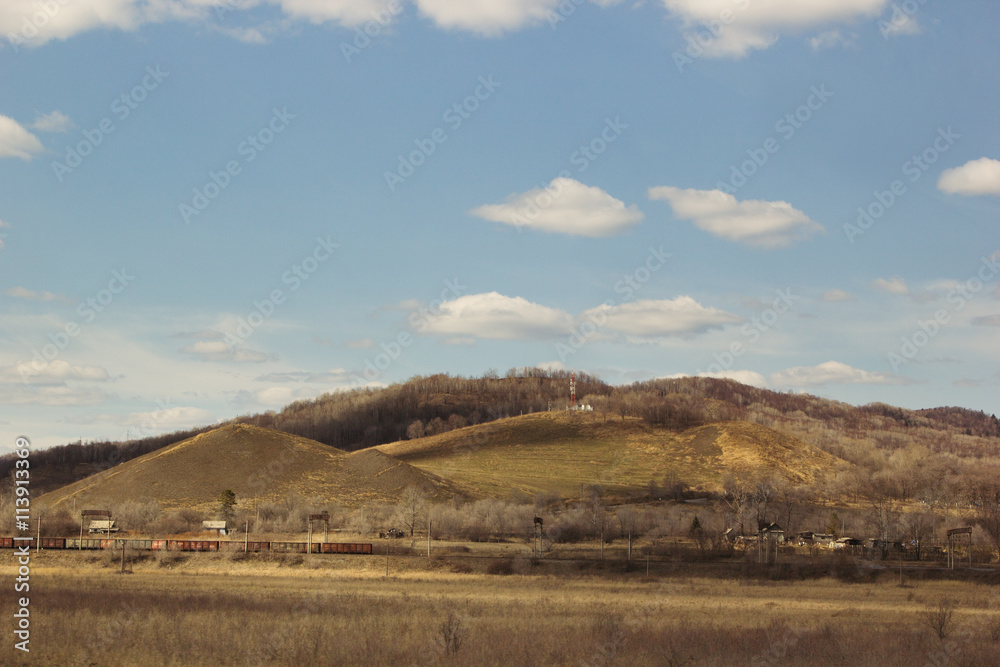 Hill and the yellow field on a clear day. Early spring, autumn. Landscape.
