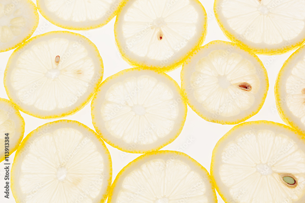 Slices of lemon on a white background. Pattern. Macro. Fruit background. Slices of lemon on a white background. Pattern. Macro. Fruit background.