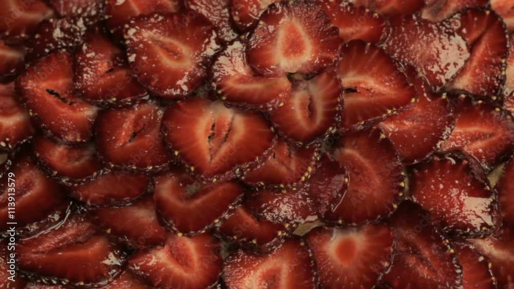 Red slices of fresh strawberries, rotates counterclockwise Red slices of fresh strawberries, rotates counterclockwise