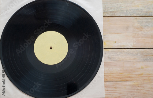 Vinyl record with copy space in front of a collection albums dummy titles, vintage process