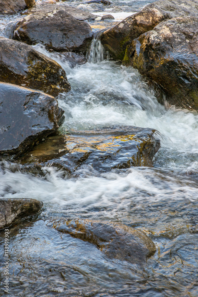 Rapid flow of the Chulcha river near Uchar waterfall, Altai, Russia.