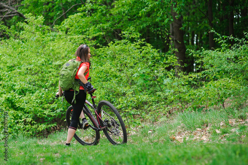 Girl riding a bike in the woods © lisovoy