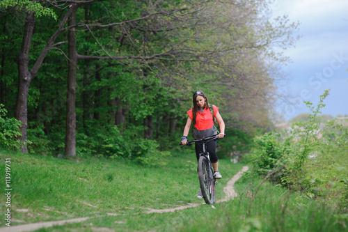 Girl riding a bike in the woods