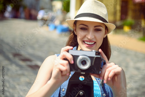 Happy woman taking photos of town © Yakobchuk Olena