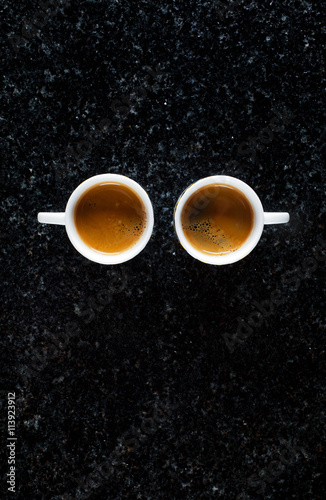 two cups of fresh Coffee Espresso on black Marble