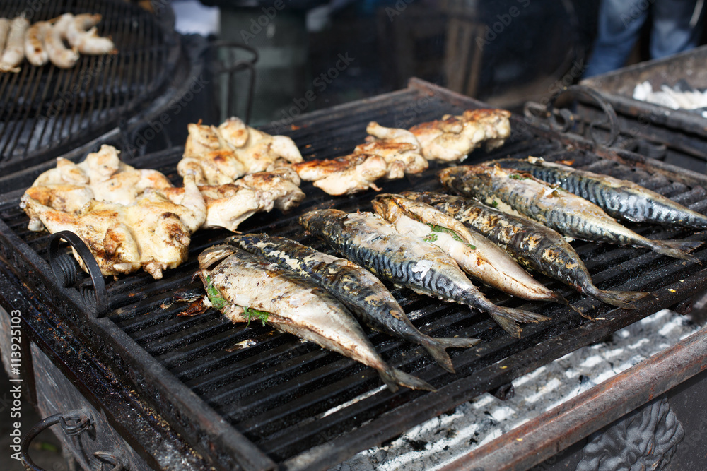Fish mackerel and chicken tabaka grilled at bbq