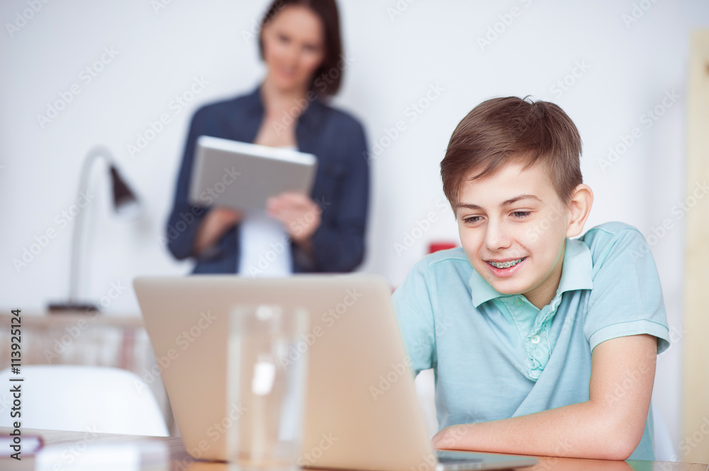 Boy using laptop at home Boy using laptop at home
