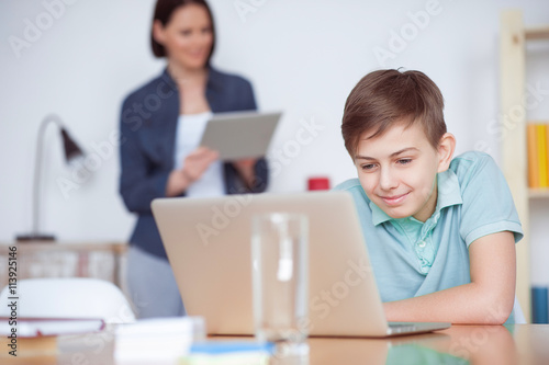 Boy using laptop at home