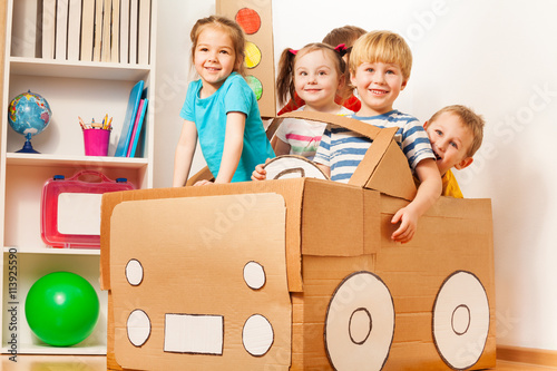 Εκτύπωση καμβά Young boy driving his friends in cardboard car