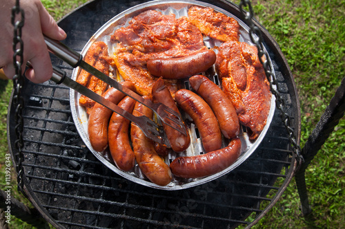 Sausages and bacon on grill tray