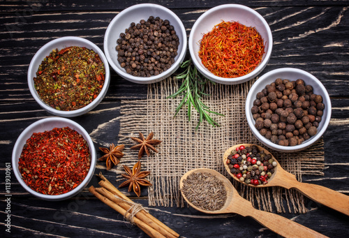 Colorful aromatic  spices and herbs on an old oak wooden brown b