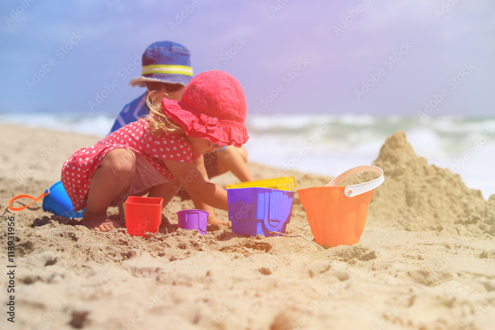 kids play with sand on summer beach kids play with sand on summer beach