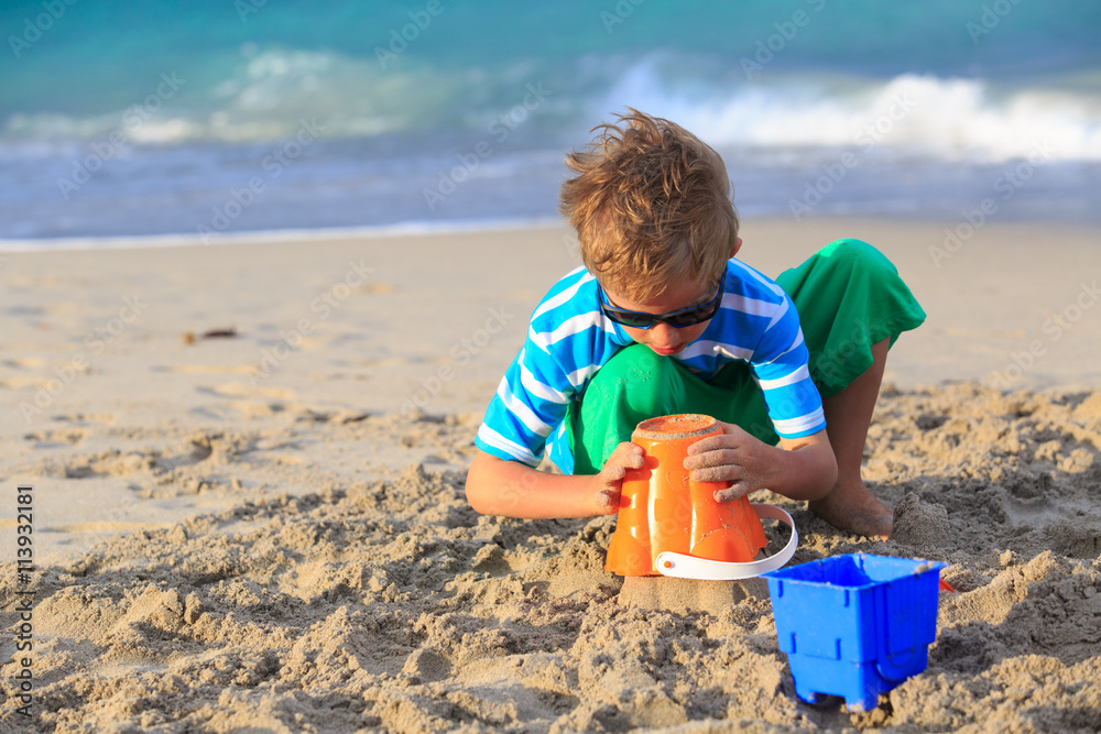 little boy play with sand on beach little boy play with sand on beach
