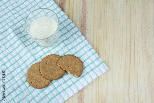 Biscuits and a glass of milk on a green napkin