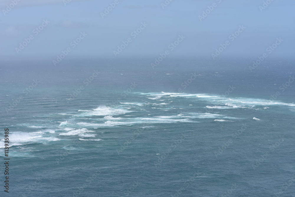 Fototapeta premium At Cape Reinga Tasman sea meets Pacific ocean.