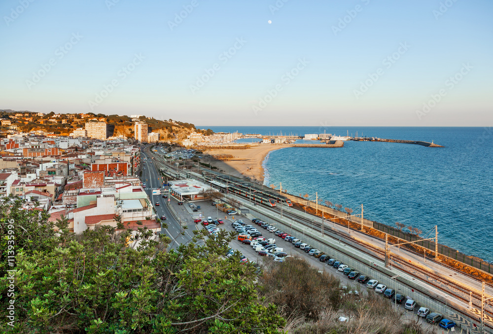View over the town, the beach and the fishing harbor of Arenys de Mar, on the mediterranean coast near Barcelona.