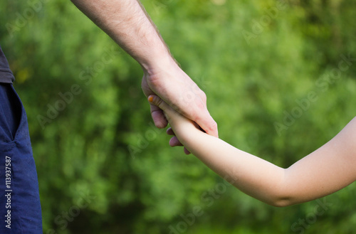 a parent holds the hand of a small child © virythtpehjljd89