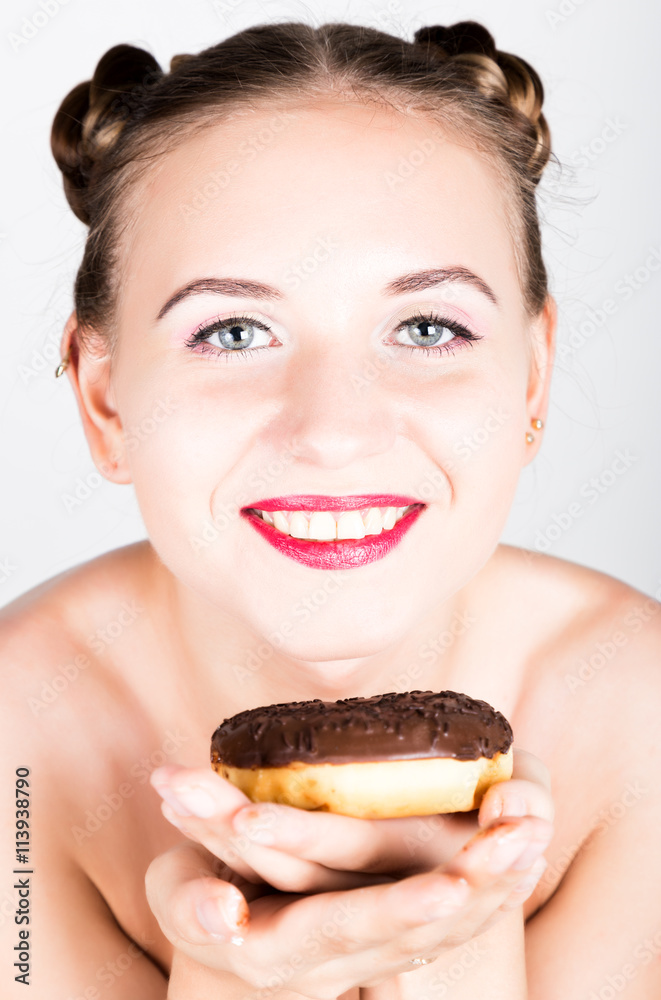 girl in bright makeup eating a tasty donut with icing. Funny joyful woman with sweets, dessert. dieting concept. junk food