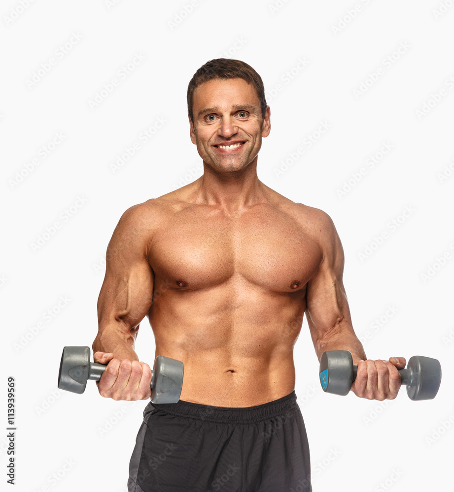 Smiling shirtless male with dumbbells.