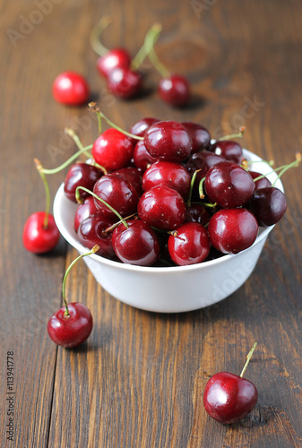 Sweet cherry in bowl on the table.