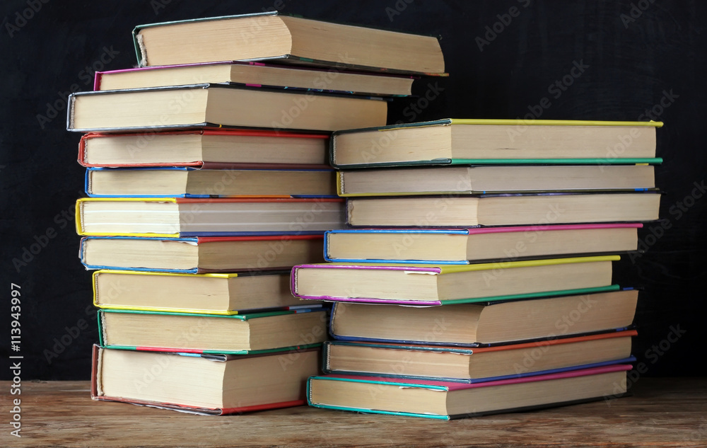 Books in stacks in the background of a school blackboard. Books in stacks in the background of a school blackboard.
