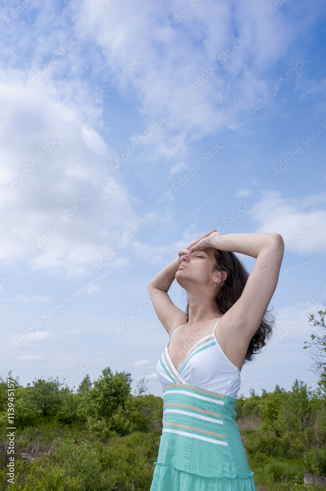 Girl sunbathes on a background summer landscape Girl sunbathes on a background summer landscape