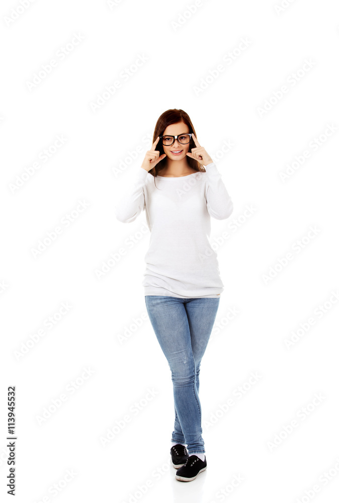Young smiling woman improves glasses Young smiling woman improves glasses