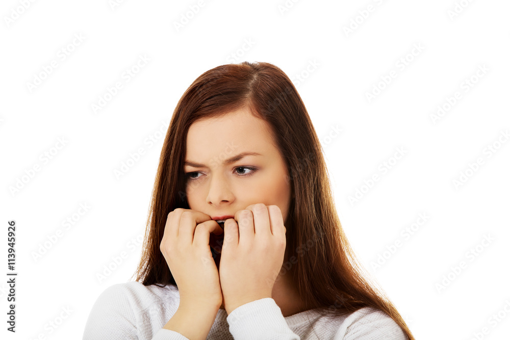 Young stressed woman biting her nails Young stressed woman biting her nails