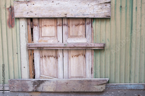 old window, sealed with wooden planks.