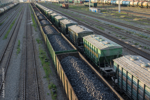 trains with industrial goods stand on the rails