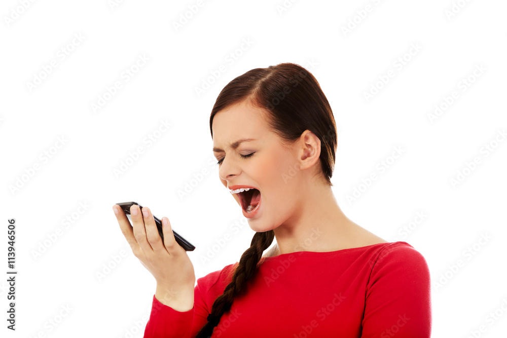 Young student woman yelling to the mobile phone Young student woman yelling to the mobile phone