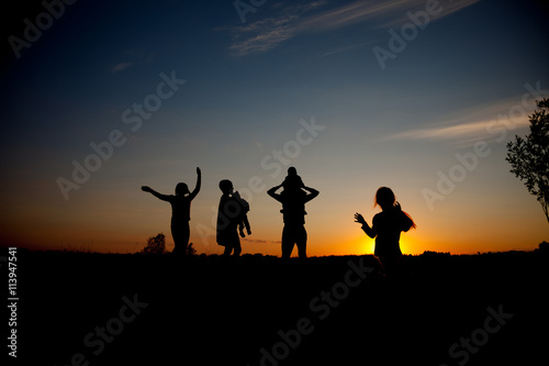silhouette of family on the outdoor at dusk.