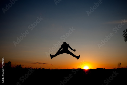 Business concept. Silhouette of a man jumping in the sunset