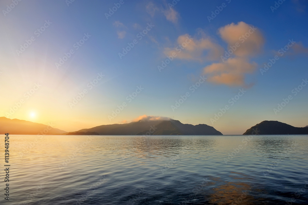 Beautiful morning seascape with mountains in the background
