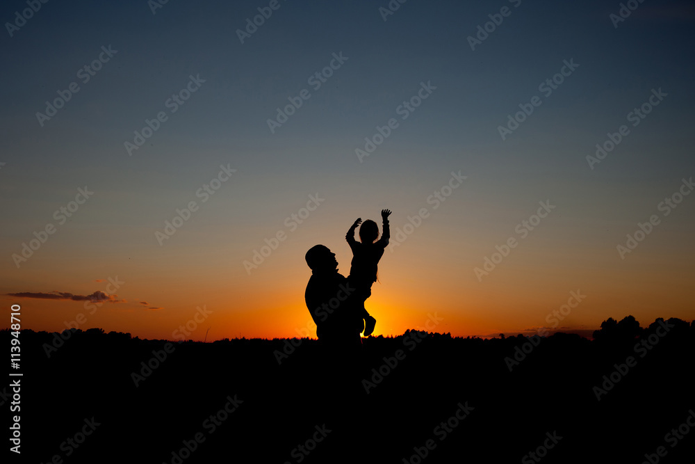 father holding and raising his child silhouette