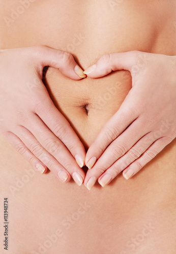 Wallpaper Mural Body care, pregnancy diet concept, woman holding hands on the stomach. Torontodigital.ca