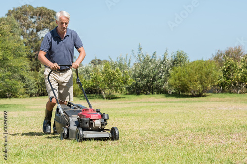 Senior gardener mowing