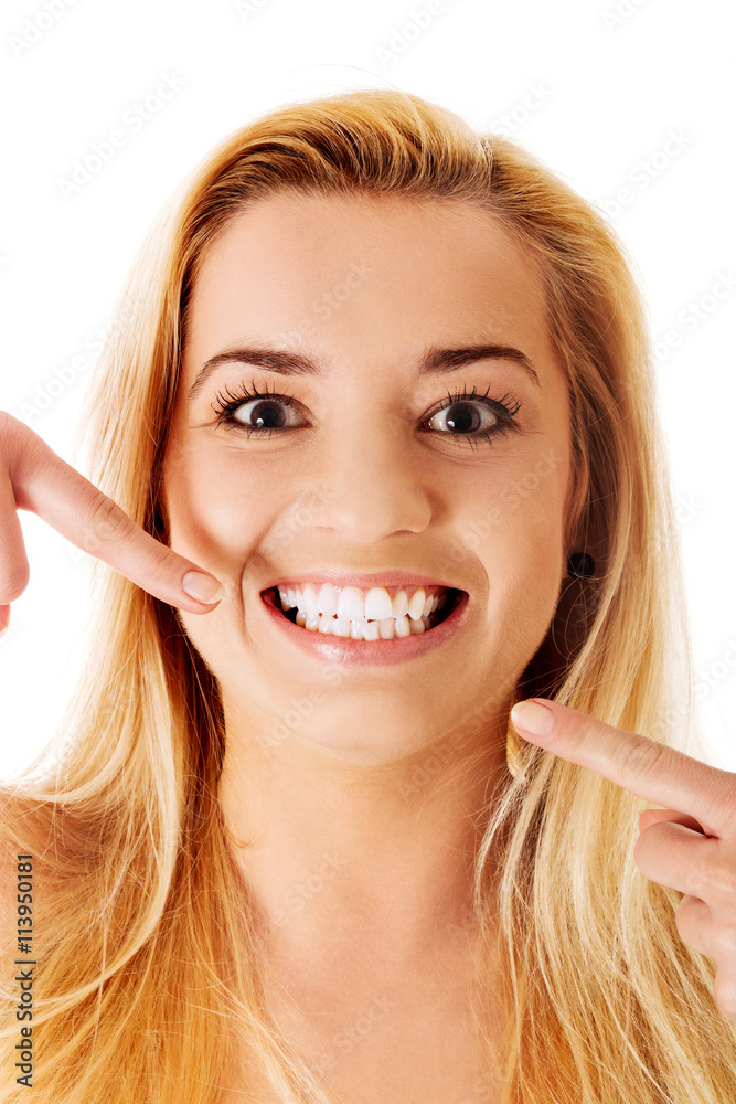 Woman showing her perfect straight white teeth. Woman showing her perfect straight white teeth.