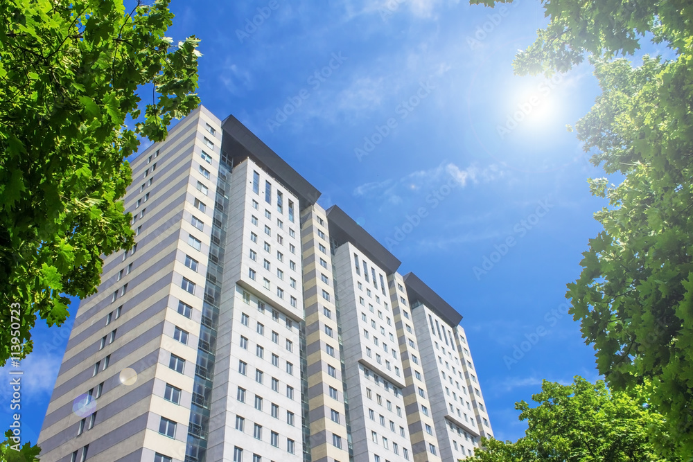 multistorey residential building surrounded by green trees multistorey residential building surrounded by green trees