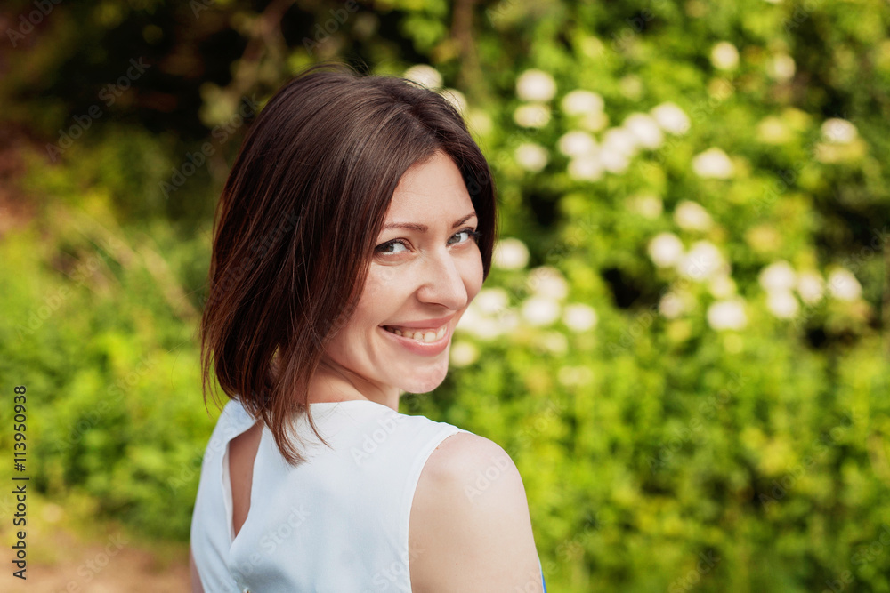 beautiful young woman smiling in the park beautiful young woman smiling in the park