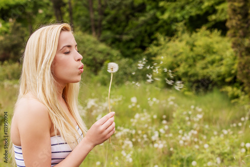 Young woman posing with flowers . Outdoor shot.