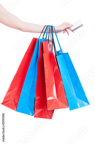 Hand holding shopping bags and credit card isolated on white
