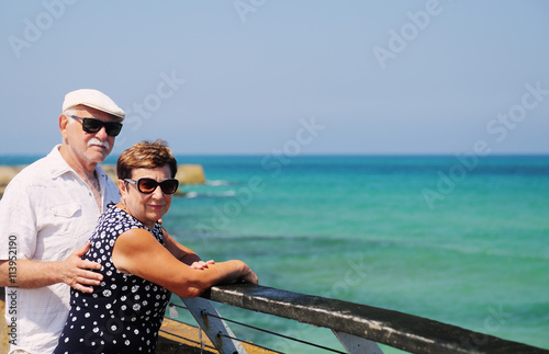 senior couple walking near the sea