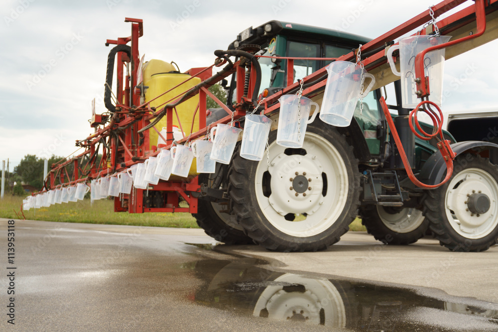 Naklejka premium Tractor spray nozzle adjustment